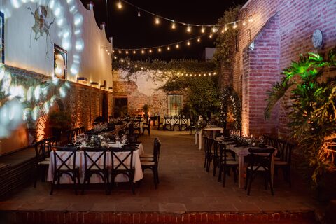 A reception space lit with strings of warm lights.